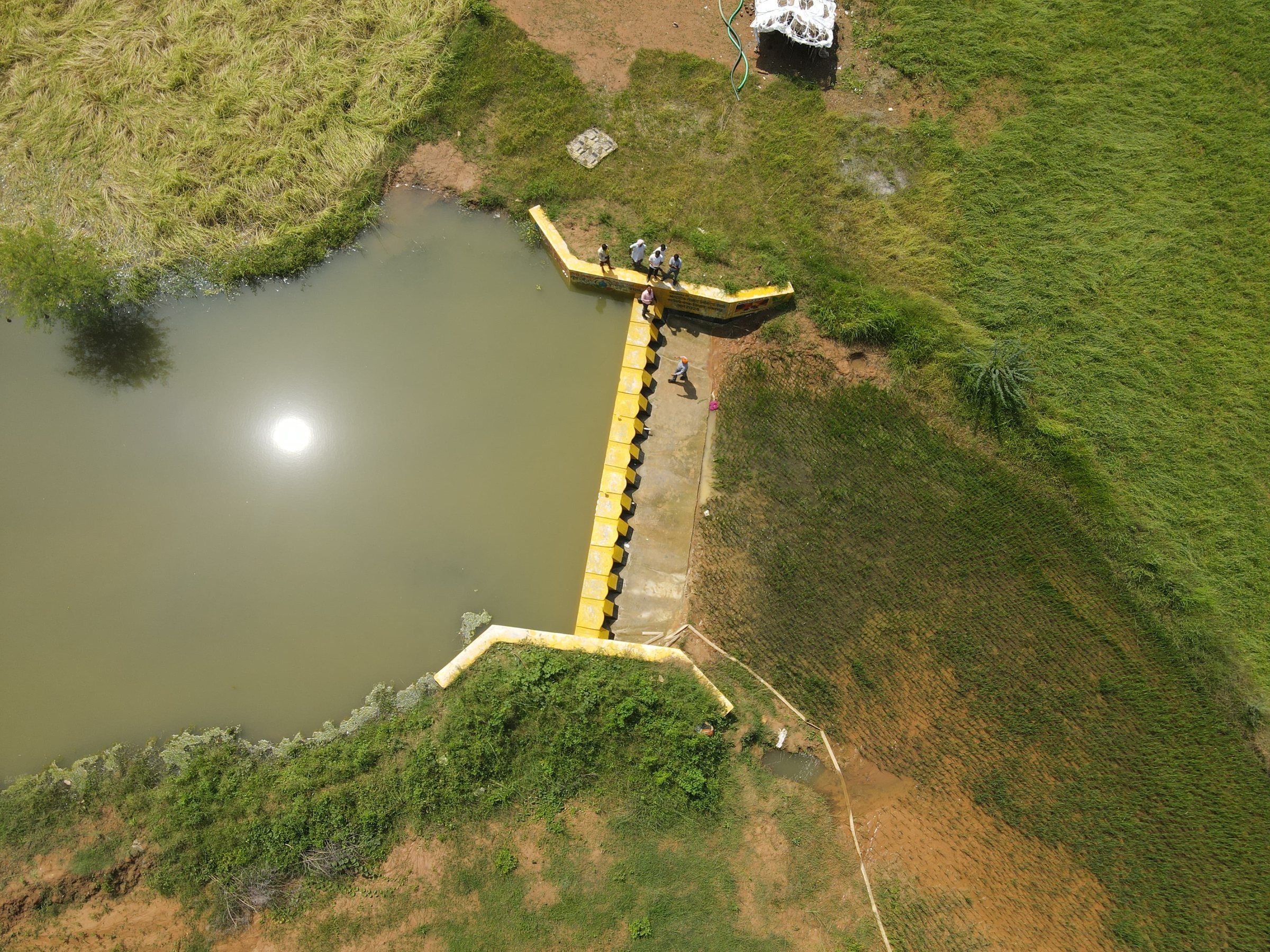 A drum check dam holding water in a stream